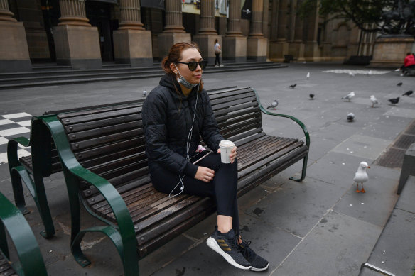 Different world: Sarah Pezzino takes a break in front of the closed State Library of Victoria.