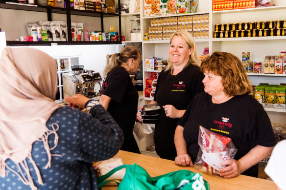 Kirsty Parkes, centre, serves visitors at her Community Cafe Outreach Service in Sadleir, along with her team of volunteers.