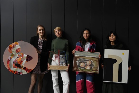 Artists Marie Pol, Giorgia McRae, Gabrielle Penfold and Cat Yenn holding their artworks at the Affordable Art Fair. 