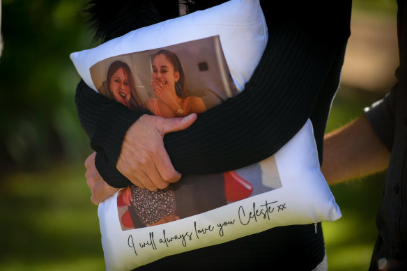Celeste Manno's mother, Aggie Di Mauro, clutches a pillow with a photo of her daughter.