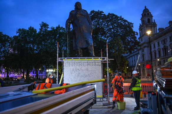 Workers erect the protective barrier under the cover of darkness. 