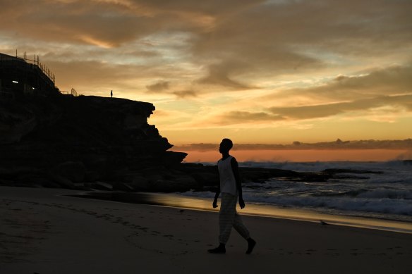 COMMAS showed its range, including its first women’s designs, at sunrise at Sydney’s Tamarama Beach.