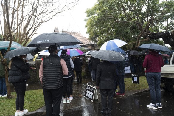 Buyers braved the wet weather for the auction of 3 Gladstone Ave, Hunters Hill, which sold for $4.47 million.