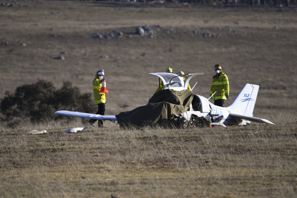 Fire and Rescue personnel near the wreckage of a light plane which crashed near Braidwood on Tuesday, killing the pilot.