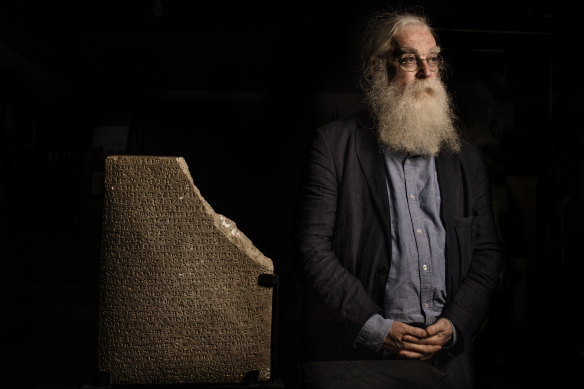 Irving Finkel at the Nicholson Museum with an inscribed tablet on loan from the Australian Institute of Archaeology.