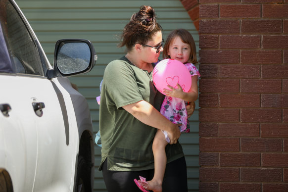 Cleo Smith is carried inside a friend’s house by her mother on November 4 in Carnarvon, Western Australia.