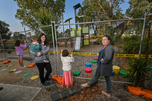 Residents Simone Hocking with her children and Rachel Matton at the playground where their kids used to play.