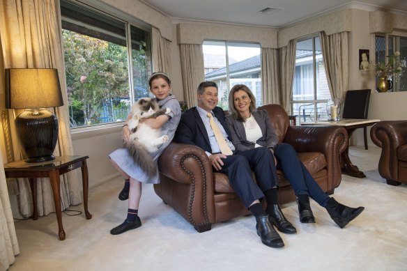 Orange couple Michael Jones and Michelle Knighton-Jones, with their daughter Elizabeth, 7, and Meatball the cat. 