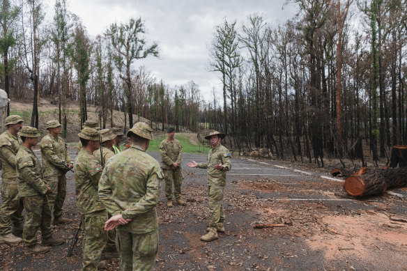 Colonel Warwick Young addresses ADF troops working at the Botanic Gardens in Mogo.