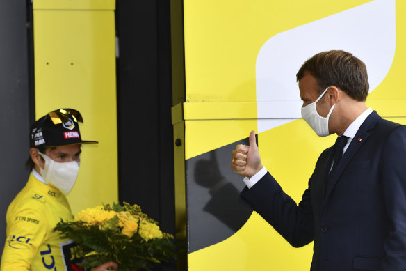 French President Emmanuel Macron gives a thumbs up to Tour leader Primoz Roglic.