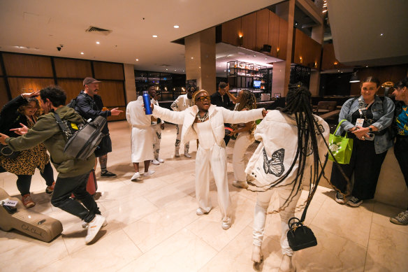 Womadelaide performers sing happy birthday to Sampa the Great in the lobby of the Hilton.