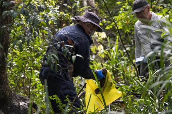 Police bag a scrap of fabric on Tuesday at the new search site.