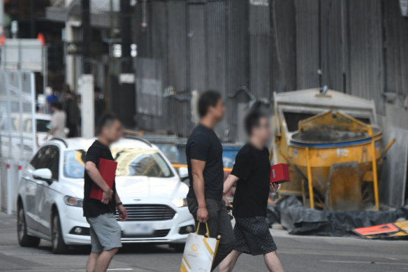 Three people of interest attend a Melbourne restaurant in this surveillence photo supplied by the Australian Federal Police.