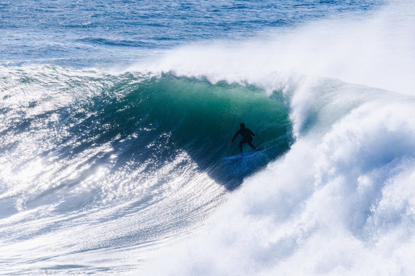 A surfer riding a wave at Dead Man’s, a break near Fairy Bower, Manly, on Tuesday. This break only works during large swells.