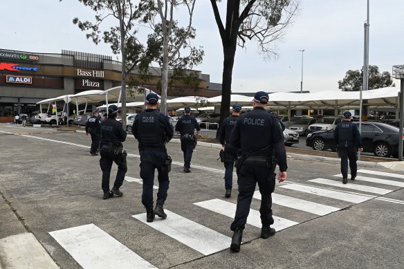 Police arrive at Bass Hill Shopping centre in preparation for a possible protest.