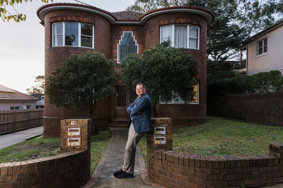 Drew Brian Hoy, who runs Instagram account Forgotten Sydney, outside an art deco apartment block in Drummoyne. 
