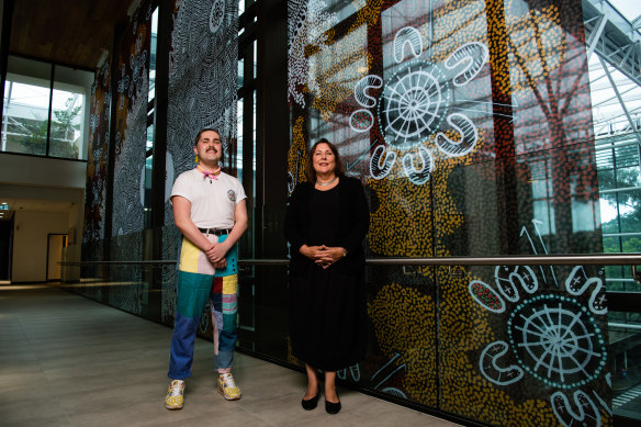 Professor Martina Möllering  and  university student Dylan Barnes with their large-scale artwork in the new $125 million Arts Precinct at Macquarie University.