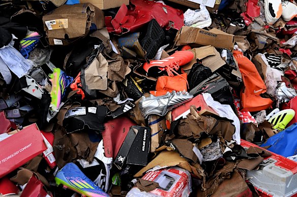 A pile of water damaged shoes on the street in Taree after the sport store was flooded. 