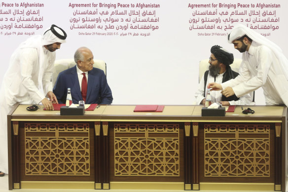 US envoy Zalmay Khalilzad (left) and Taliban leader Abdul Ghani Baradar sign the "Agreement for Bringing Peace to Afghanistan" in the Qatari capital Doha.