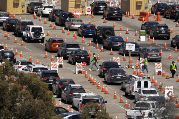 Cars queue at a drive-through coronavirus testing site at Dodger Stadium in Los Angeles last month.