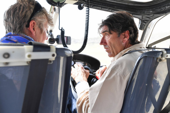 Helicopter pilot Col de Pagter (right) and Acacia Rose before takeoff to inspect Kosciuszko National Park in November.