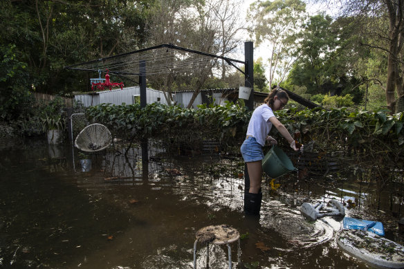 Ruby Bugeja, 13, helping clean her flooded home.