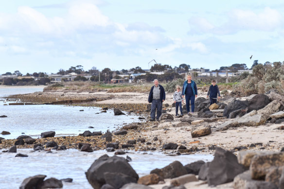 Vicki Perrett and her husband John with grandsons, eight-year-old Xavier Litjens (in black) and Sam Litjens, 6, are concerned about rising sea levels in Indented Head,
