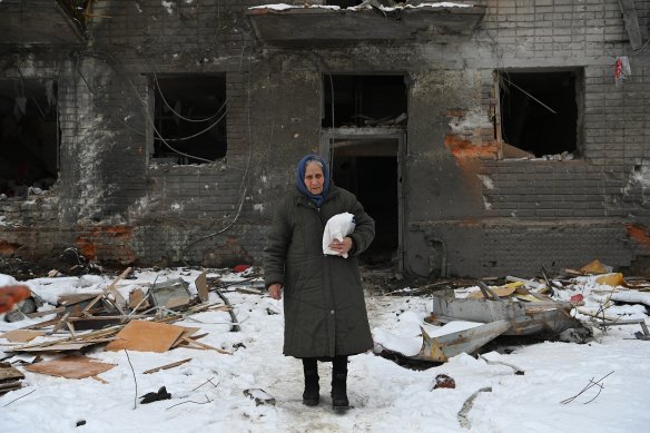 A woman emerges from a destroyed building in Kharkiv, Ukraine. 