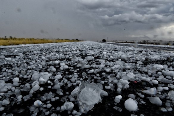 Giant hail covers the road north of Bourke as storms sweep through the region