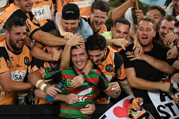Rabbitohs utility Dean Hawkins mobbed by his junior club teammates after his debut game. 