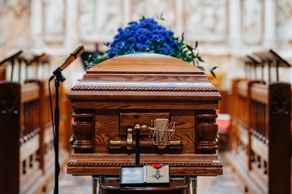John Laws’ coffin at St Andrew’s Cathedral, flanked by his golden microphones.