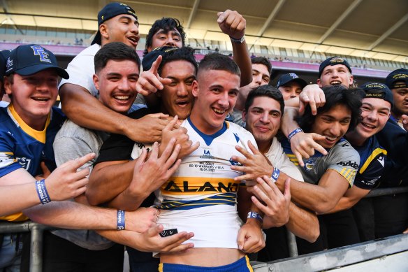 Jake Arthur celebrates with mates after scoring on debut for Parramatta in 2021.