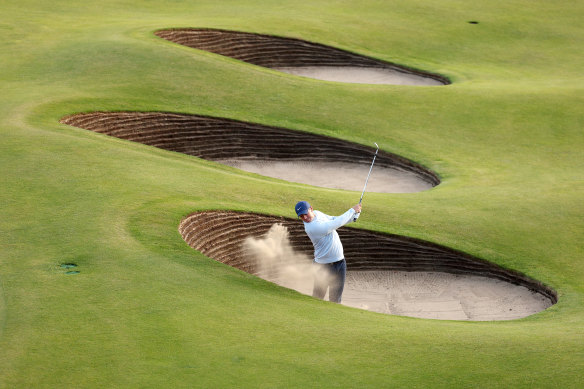 Rory McIlroy hits out of a bunker on the 18th hole during his first round at Hoylake.