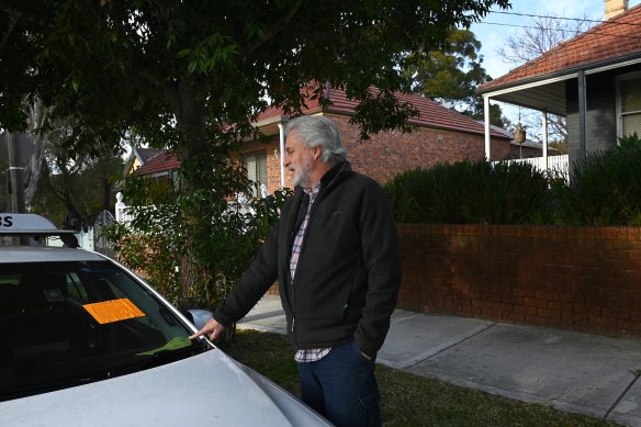 A dumped taxi in the residential part of Renwick Street, Marrickville, hit with a council notice to impound.