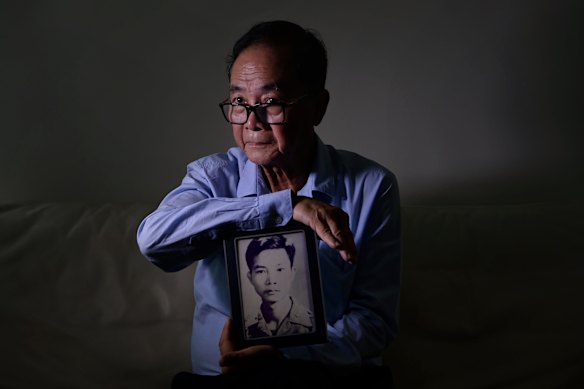 Al Chi Hoang with a portrait of himself as a young man in the South Vietnamese army.