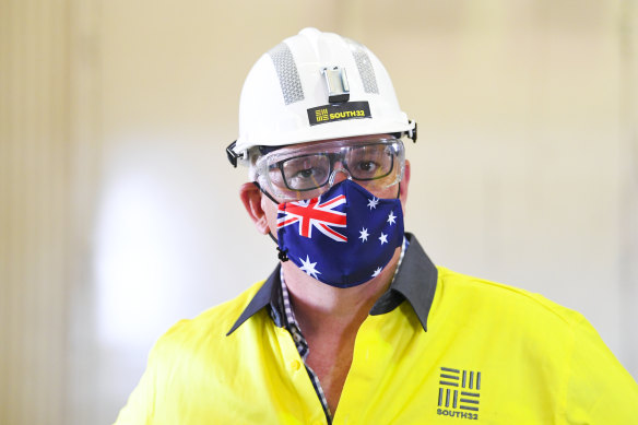 Prime Minister Scott Morrison wears a hard hat and face mask during a visit to South32 Cannington Mine in McKinlay, Queensland on Wednesday.