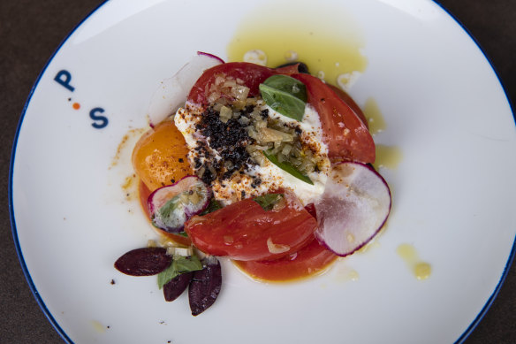 Heirloom tomato, Burrata Stracciatella, olives, confit onion dressing with oregano at the Portside Restaurant.