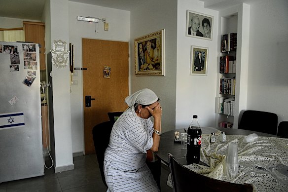 Shontal Okanine gets back in his house after a flat apartment building has been struck by an iranian dancing in Beersheba, Israel, Tuesday.