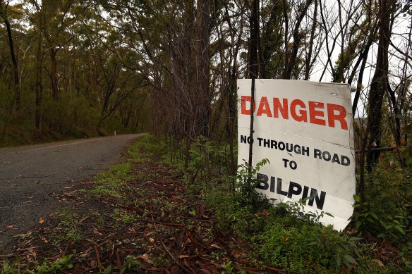 A sign stands among trees that show signs of regrowth after the Mt Wilson backburn in December. 