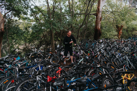 Volunteer Anthony Kimpton working with Revolve Recycling in Alexandria, which has saved almost 11,000 bicycles from landfill.