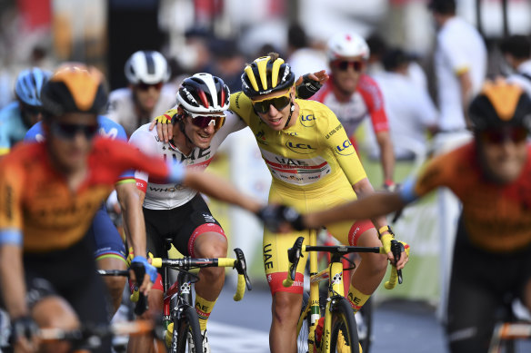 Tadej Pogacar celebrates winning the Tour de France.