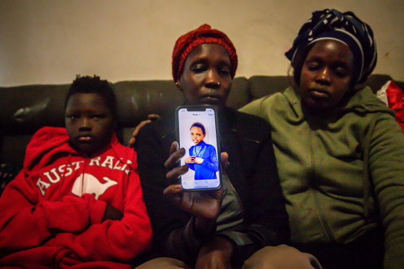 Atit Deng holds a photo of her daughter Aluel, who was killed when a car hit her in Werribee on Wednesday night.