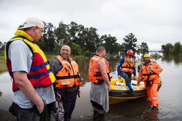 SES volunteers picking up Brian McGregor and Jason Pemberton from their home at Wilberforce caravan park on Tuesday afternoon.