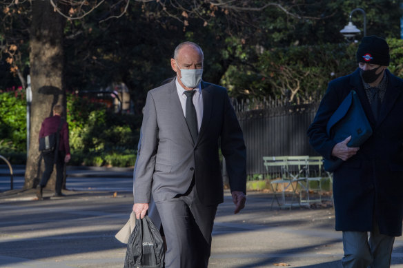 Chris Dawson (centre) arrives at the NSW Supreme Court on Friday.