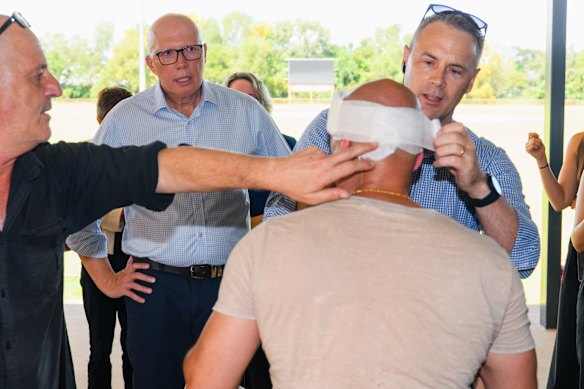Dutton checks on injured cameraman Ghaith Nadir.
