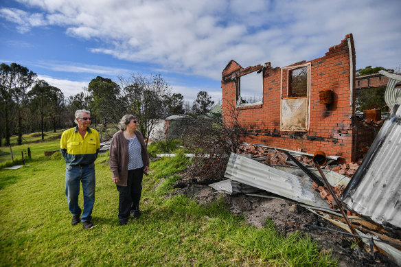 Lyn and Allan Wallwork in June beside their destroyed Sarsfied home, which has since been demolished.