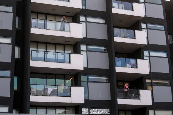 Residents in their locked-down apartments on Tuesday.