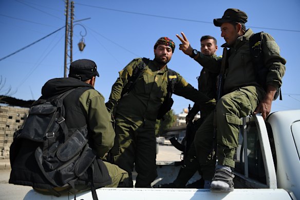 Kurdish security forces patrol near a  demonstration following an agreement between Russia and Turkey that could see their people removed from the border with Turkey.