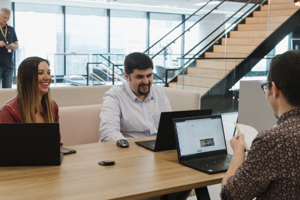 Anthony Kyle, who is on the autism spectrum, works for SAP in Sydney in the finance team. Mr Kyle (right) is with chief financial officer Gina McNamara and another team member.