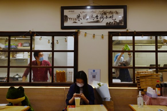 Mother Chu’s owner Alan Chu peers through the window from his restaurant’s kitchen in Chinatown.